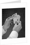 Male hands holding hand poker cards 4 aces and a king by Anonymous