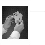 Male hands holding hand poker cards 4 aces and a king by Anonymous