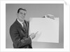 Smiling man pointing to blank poster by Anonymous