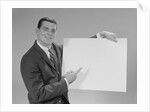 Smiling man pointing to blank poster by Anonymous
