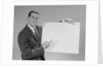 Smiling man pointing to blank poster by Anonymous