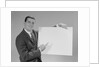 Smiling man pointing to blank poster by Anonymous