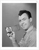 Smiling man holding up wallet with picture of wife and daughter by Anonymous