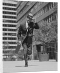 Businessman carrying briefcase holding his hat on running down urban sidewalk by Anonymous