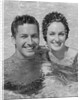 Smiling couple man woman in swimming pool by Anonymous