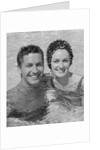Smiling couple man woman in swimming pool by Anonymous