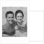 Smiling couple man woman in swimming pool by Anonymous
