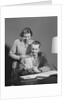 Couple man seated at desk holding paper woman standing looking over his shoulder smiling happy by Anonymous