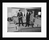Furniture store salesman talking to couple by Anonymous