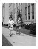 Boy girl running down sidewalk carrying school books smiling by Anonymous