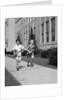 Boy girl running down sidewalk carrying school books smiling by Anonymous