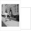 Boy girl running down sidewalk carrying school books smiling by Anonymous