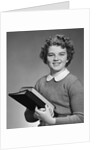 Adolescent teen girl smiling portrait holding school books by Corbis