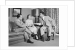 Couple sitting on couch talking to smiling insurance salesman handing them a policy by Anonymous