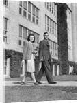 College couple walking on campus before ivy covered building by Anonymous