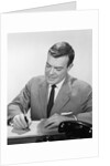 Smiling businessman at desk writing checks by Anonymous