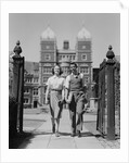 College aged student couple walking through campus gates university of pennsylvania by Anonymous