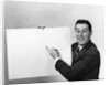 Smiling man pointing to blank poster sign by Anonymous