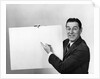 Smiling man pointing to blank poster sign by Anonymous