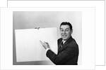 Smiling man pointing to blank poster sign by Anonymous