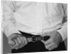 Man hands tightening belt by Anonymous