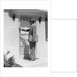 Salesman wearing suit tie hat carrying briefcase ringing suburban house doorbell by Anonymous