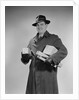 Man wearing winter coat hat gloves holding packages parcels by Anonymous