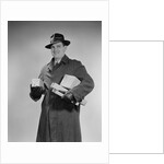 Man wearing winter coat hat gloves holding packages parcels by Anonymous