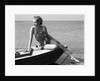 Woman wearing one piece bathing suit sitting on edge of boat by Anonymous