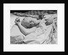 Sleeping blond woman hand over head asleep by Anonymous