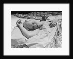 Sleeping blond woman hand over head asleep by Anonymous