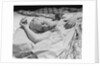 Sleeping blond woman hand over head asleep by Anonymous