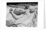 Sleeping blond woman hand over head asleep by Anonymous