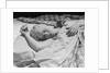 Sleeping blond woman hand over head asleep by Anonymous