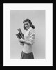 Smiling brunette teen student wearing sweater carrying school books by Anonymous
