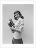 Smiling brunette teen student wearing sweater carrying school books by Anonymous
