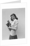 Smiling brunette teen student wearing sweater carrying school books by Anonymous