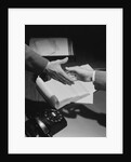 Close-up two male hands about to shake over desk with papers and telephone by Anonymous