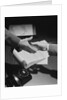 Close-up two male hands about to shake over desk with papers and telephone by Anonymous