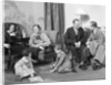 Family mother father two kids playing on floor visiting with another couple by Anonymous