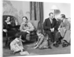 Family mother father two kids playing on floor visiting with another couple by Anonymous