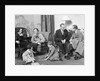 Family mother father two kids playing on floor visiting with another couple by Anonymous