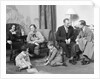 Family mother father two kids playing on floor visiting with another couple by Anonymous