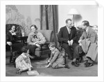 Family mother father two kids playing on floor visiting with another couple by Anonymous