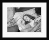 Woman sleeping asleep in bed alarm clock on night table by Anonymous