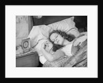 Woman sleeping asleep in bed alarm clock on night table by Anonymous