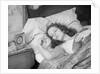 Woman sleeping asleep in bed alarm clock on night table by Anonymous