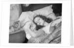 Woman sleeping asleep in bed alarm clock on night table by Anonymous