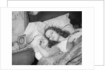 Woman sleeping asleep in bed alarm clock on night table by Anonymous