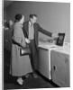 Young couple man woman shopping for washing machine by Anonymous